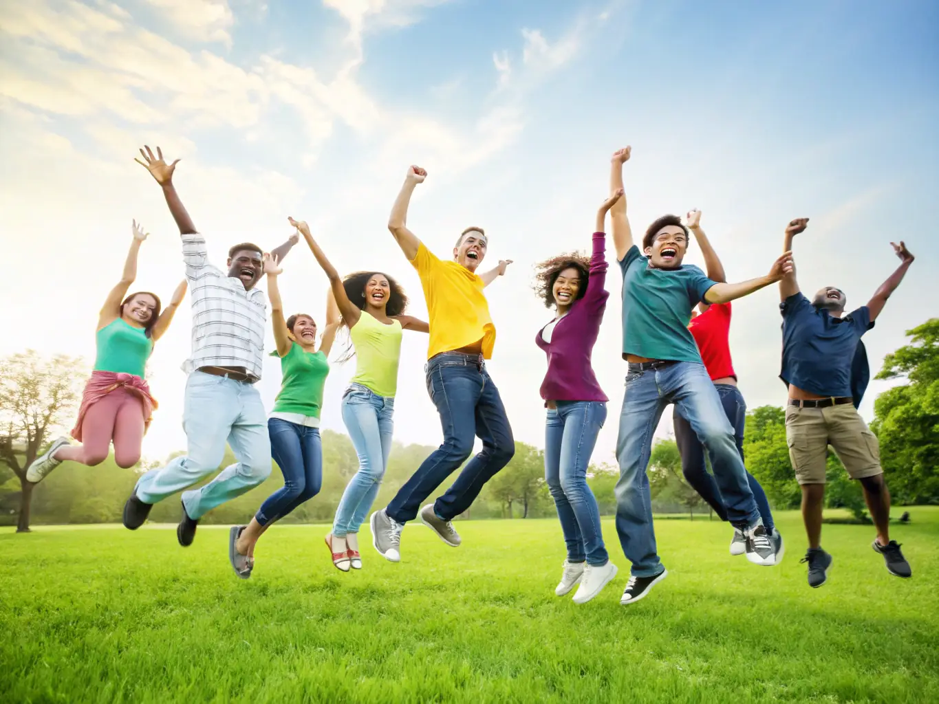 A diverse group of people smiling and laughing together after an aerobics class, showcasing the friendly and inclusive atmosphere of Energym Seboncourtoise.